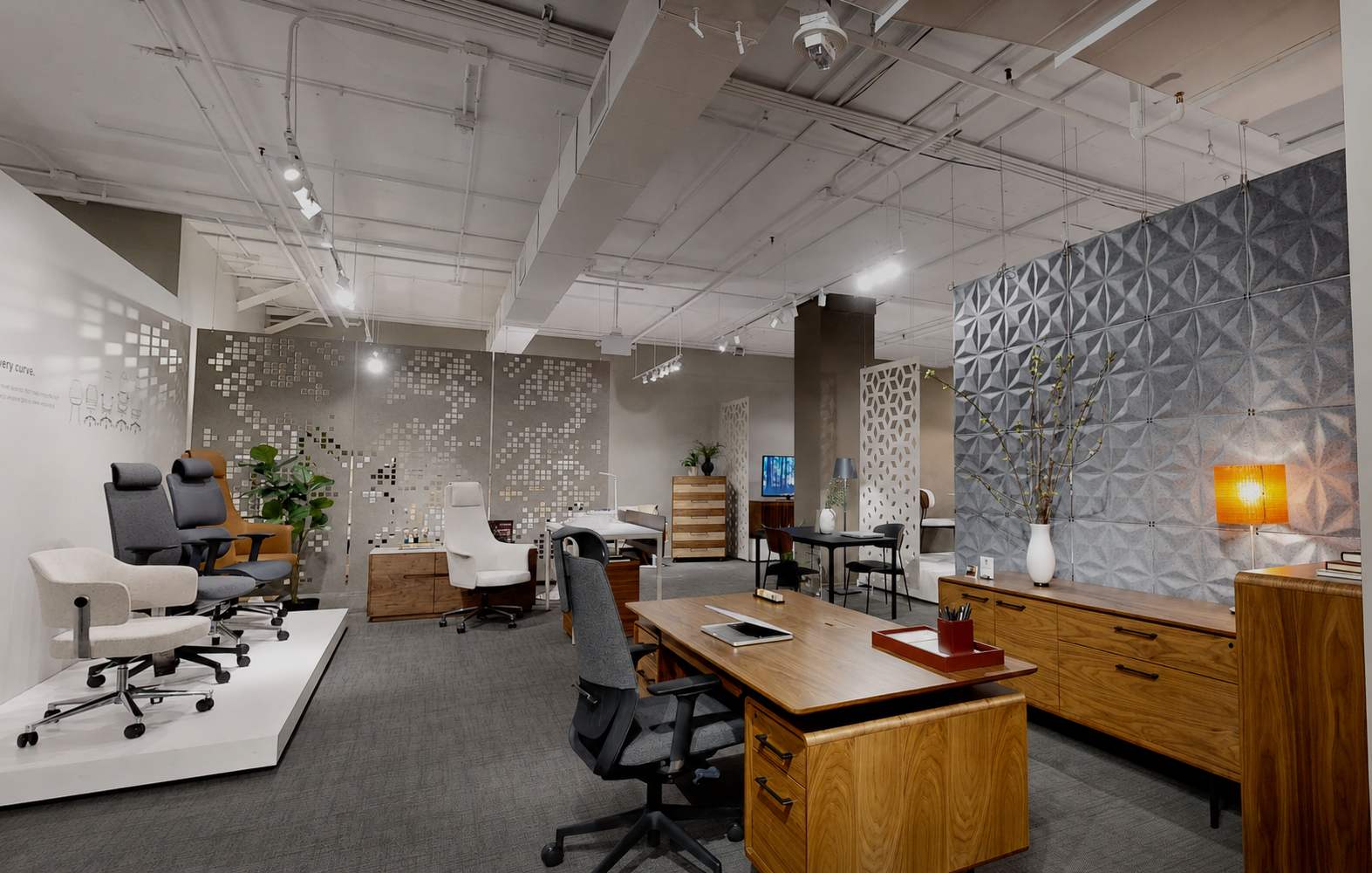 Gray Facet Harmony3D hanging acoustic panels and patterned acoustic room dividers in the BDI High Point showroom