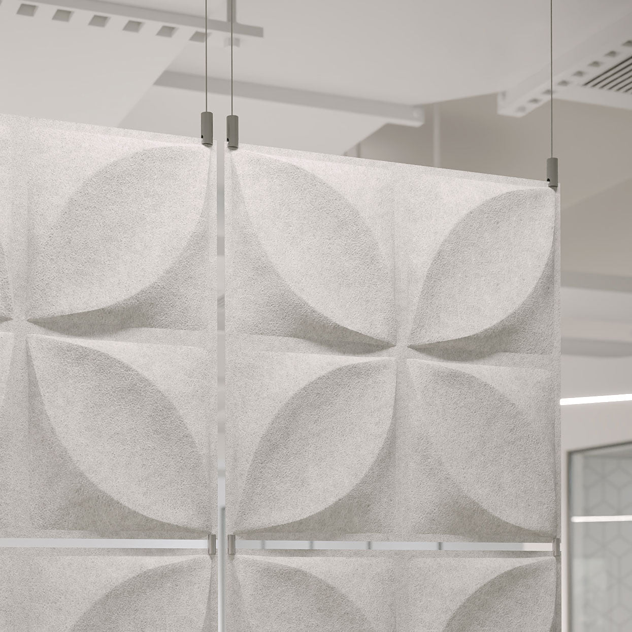 Aircraft cable hangers and panel clamps by Inhabit supporting a white PET felt acoustic divider