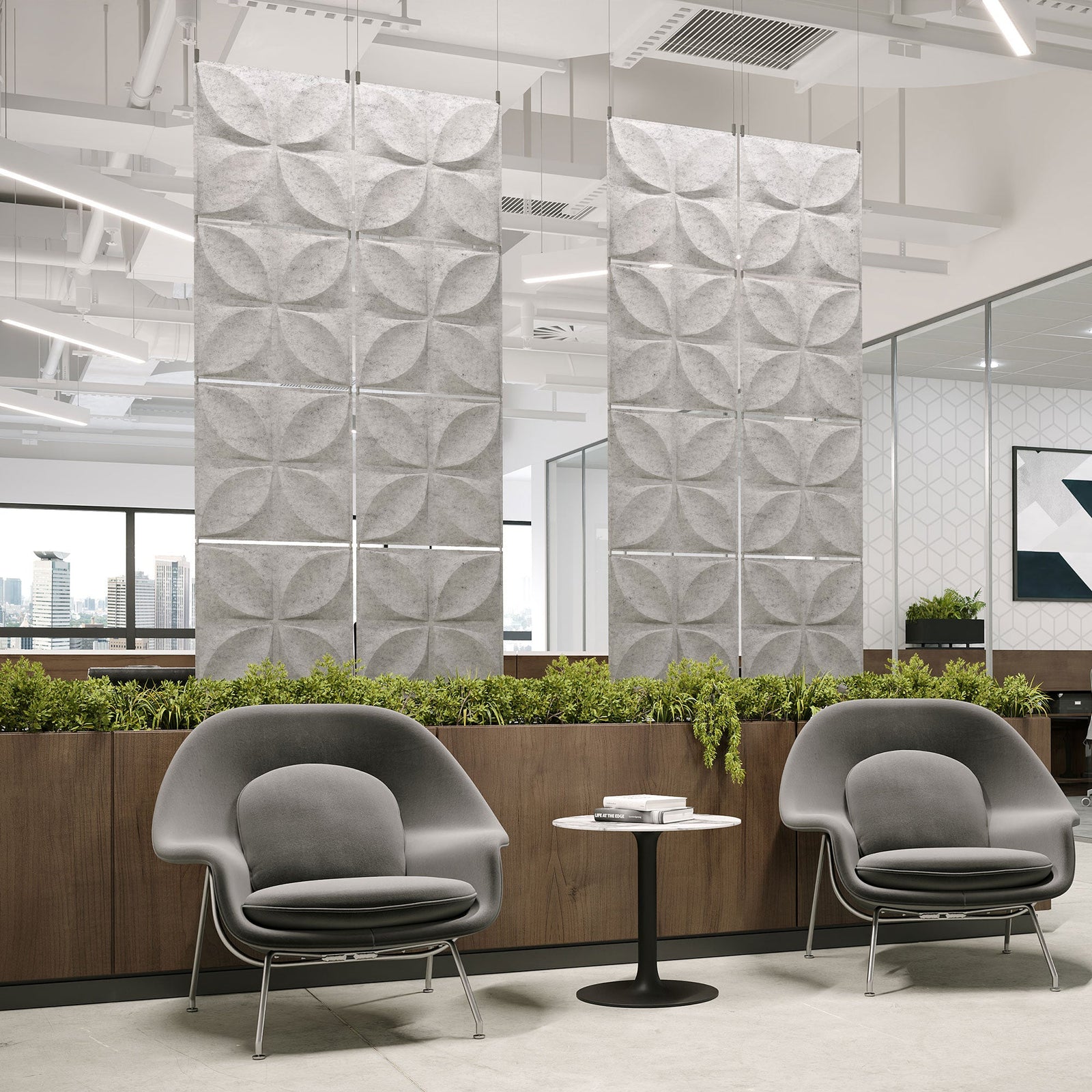 Light gray Chrysalis Harmony3D PET felt hanging acoustic panels dividing a modern office seating area by Inhabit