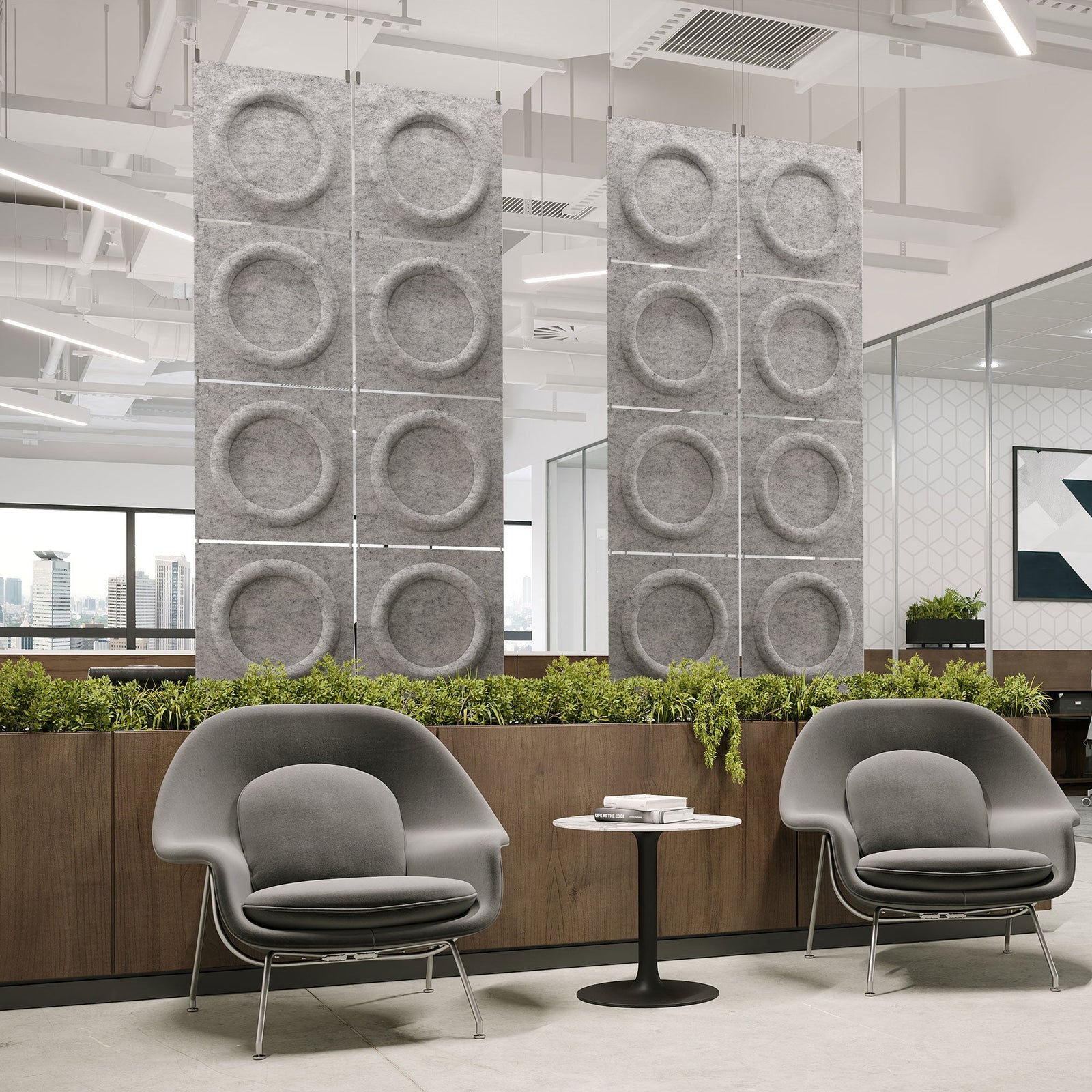 Light gray Halo Harmony3D PET felt hanging acoustic panels dividing a modern office seating area by Inhabit