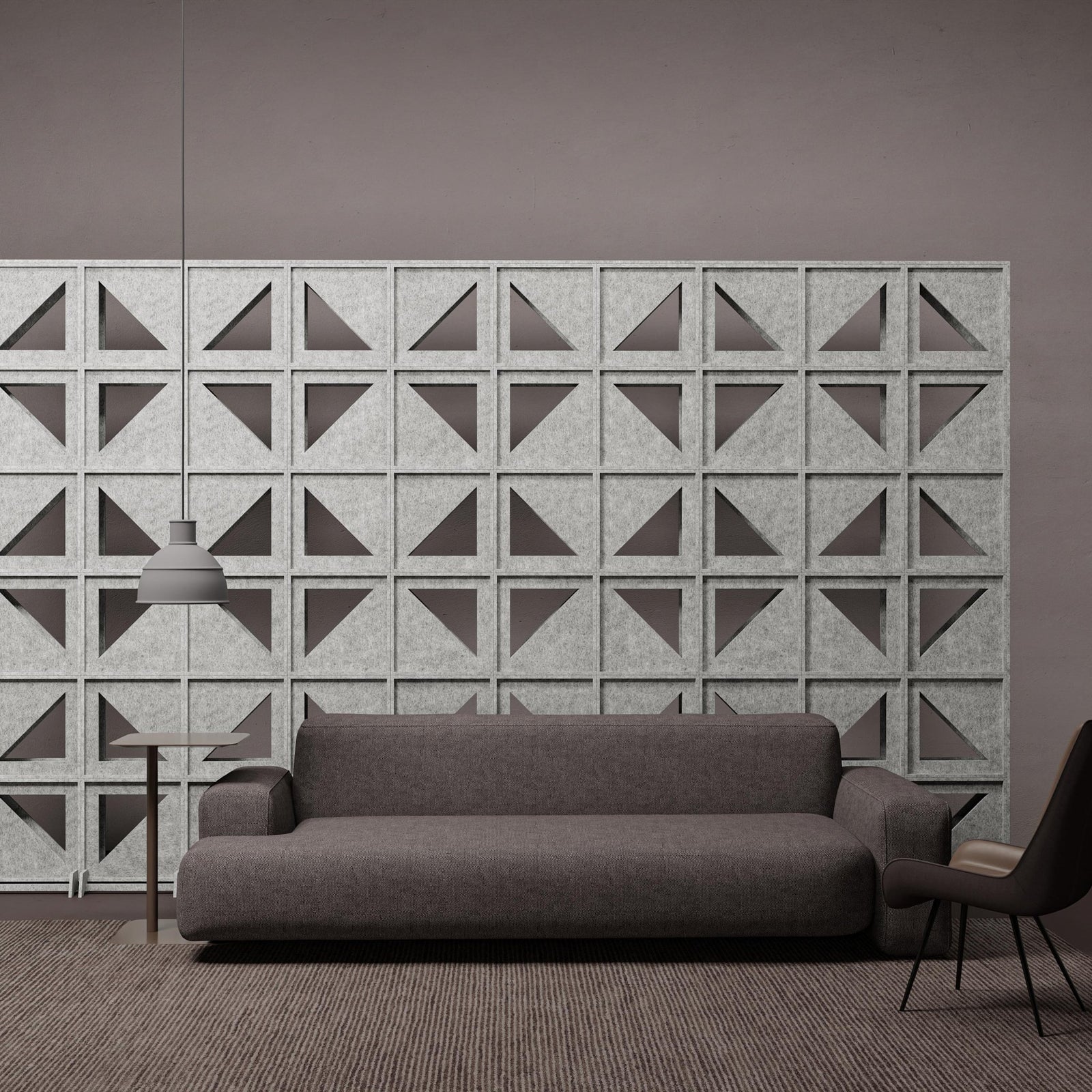 Hatch HarmonyBLOKS PET felt acoustic room divider behind a gray sofa by Inhabit.