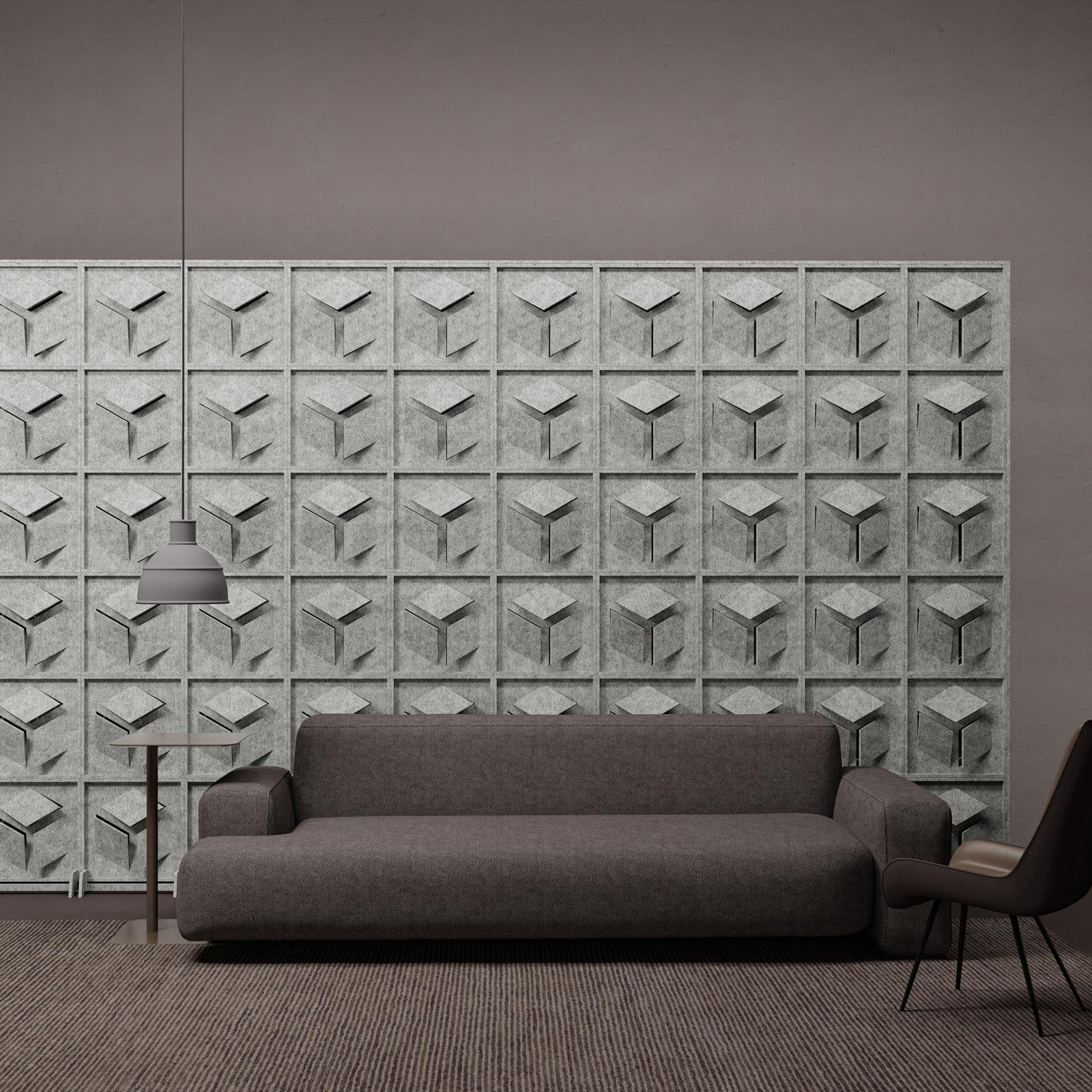 Hex HarmonyBLOKS PET felt acoustic room divider behind a gray sofa by Inhabit.