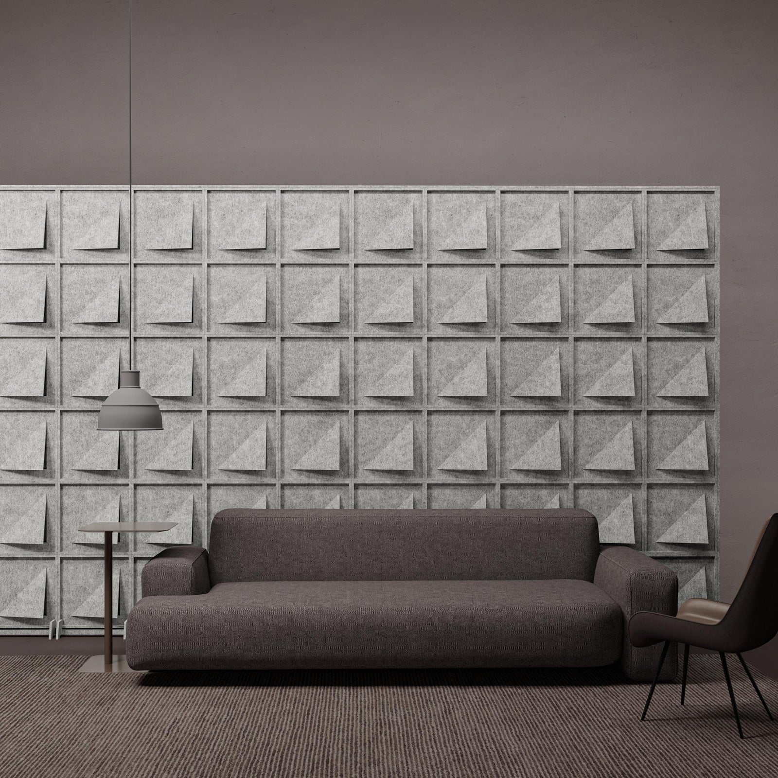 Joist HarmonyBLOKS PET felt acoustic room divider behind a gray sofa by Inhabit.
