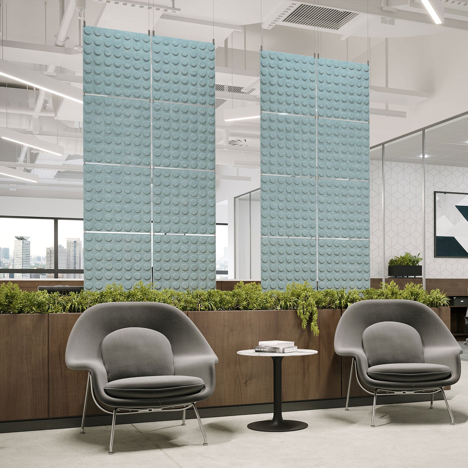 Pale blue Loop Harmony3D PET felt hanging acoustic panels dividing a modern office seating area