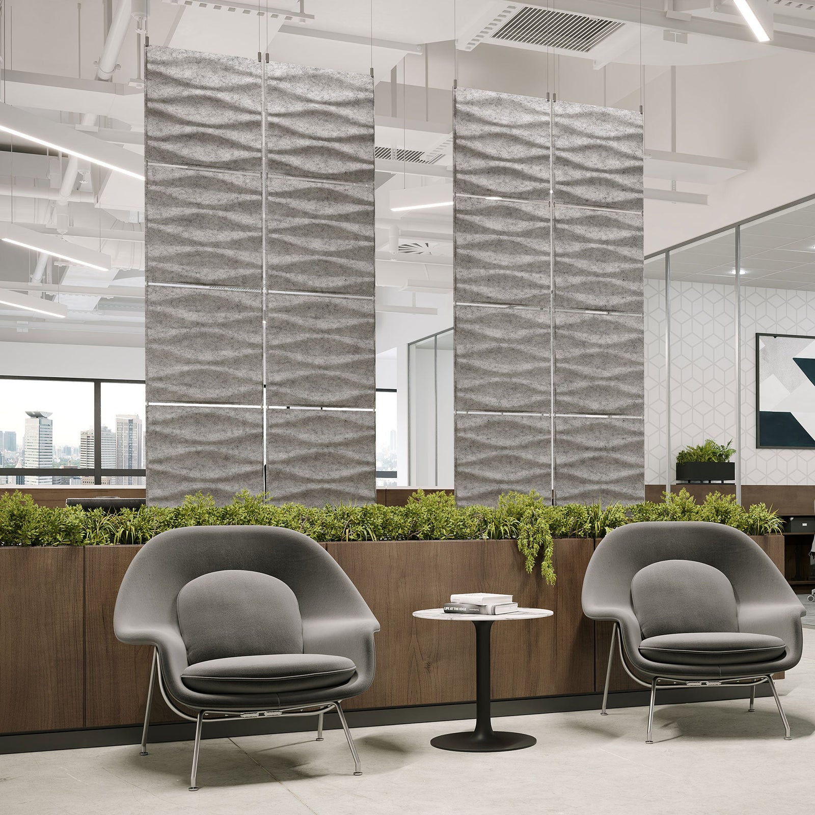 Light gray Origami Harmony3D PET felt hanging acoustic panels dividing a modern office seating area by Inhabit
