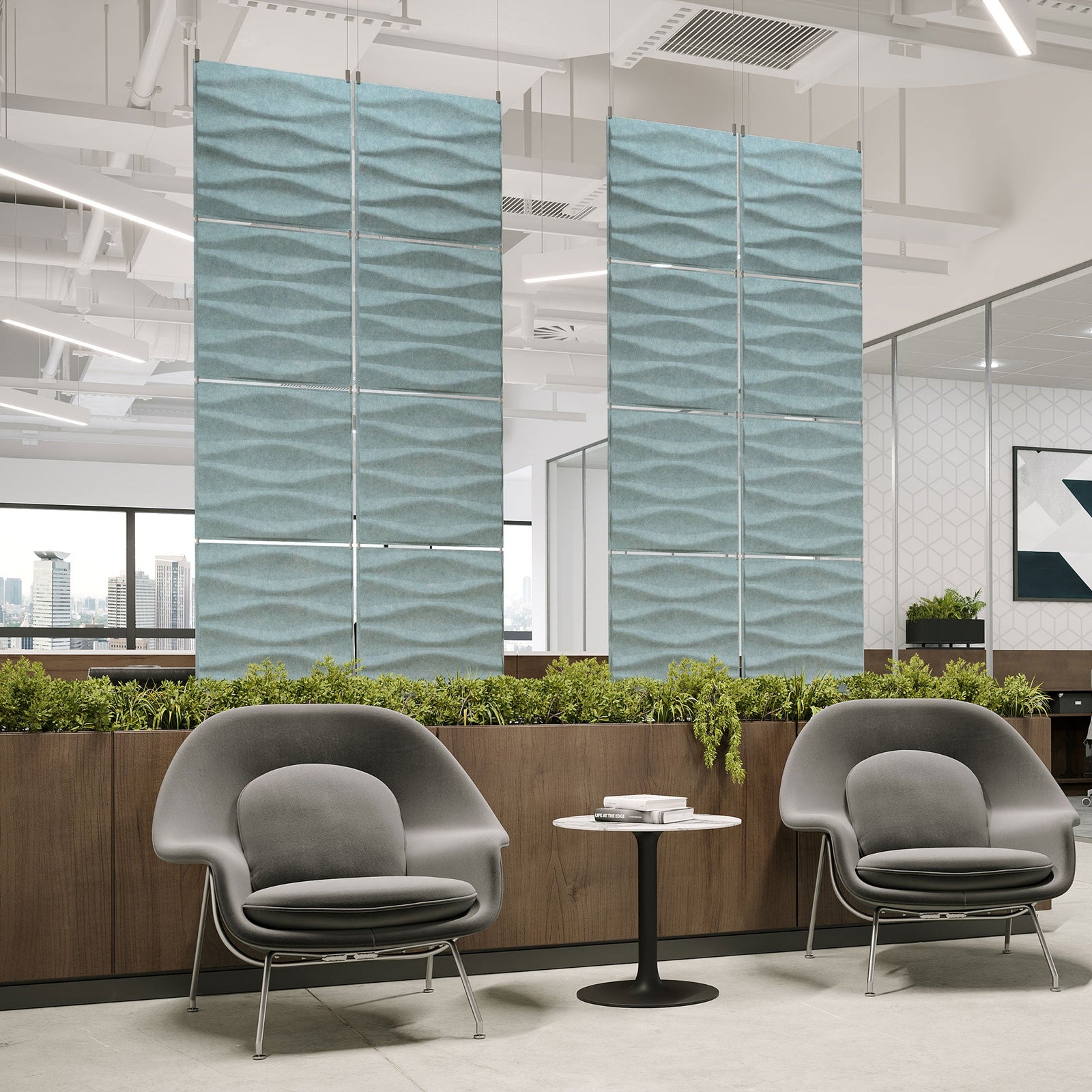 Pale blue Origami Harmony3D PET felt hanging acoustic panels dividing a modern office seating area