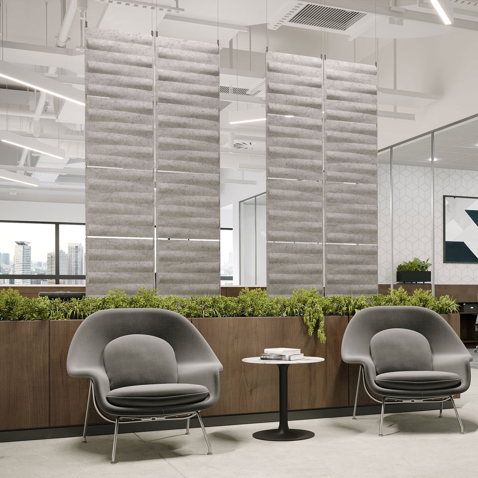Light gray Seesaw Harmony3D PET felt hanging acoustic panels dividing a modern office seating area by Inhabit