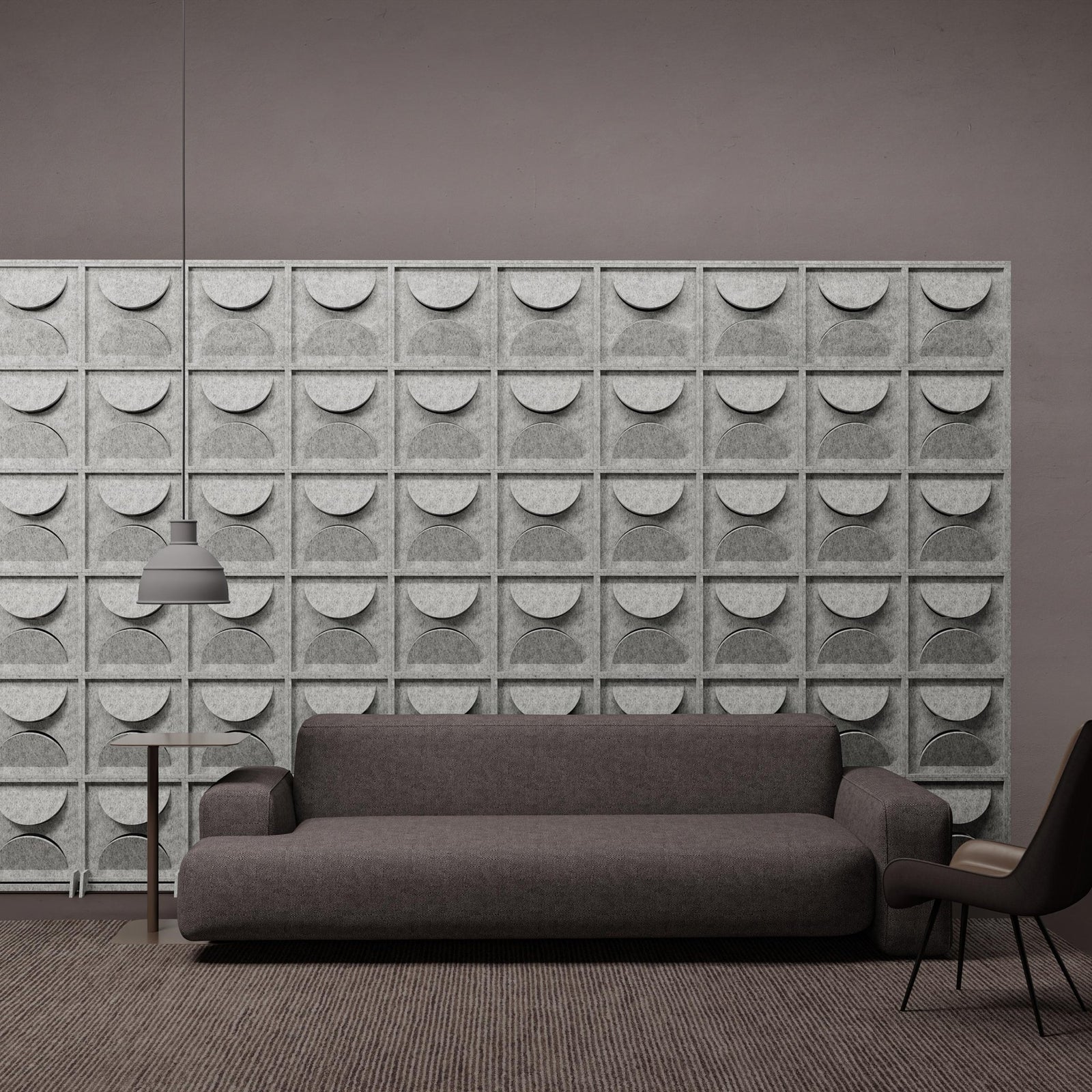 Semi HarmonyBLOKS PET felt acoustic room divider behind a gray sofa by Inhabit.
