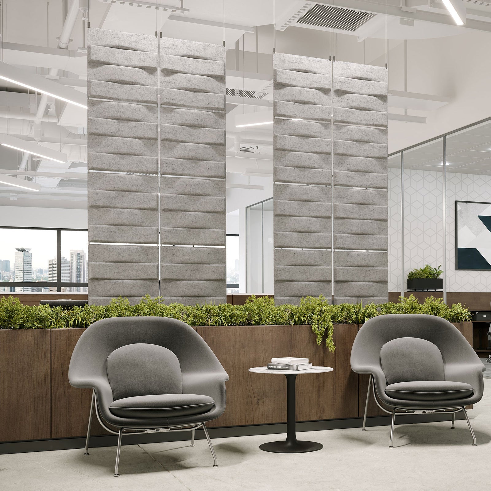 Light gray Stitch Harmony3D PET felt hanging acoustic panels dividing a modern office seating area by Inhabit